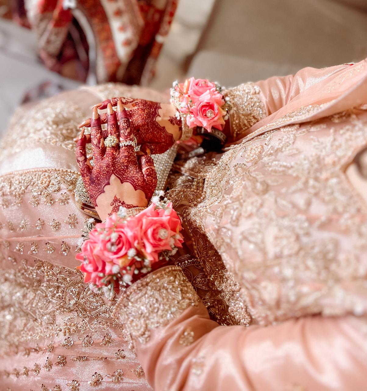 Bride wearing pink rose gajra