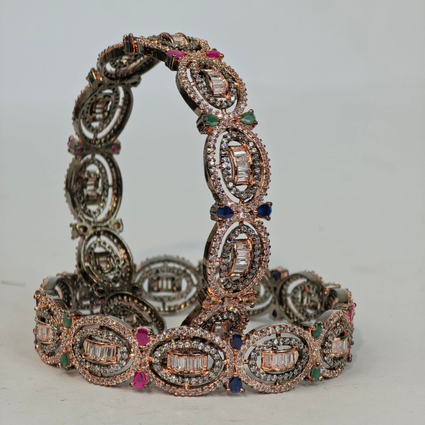 Decorative bracelet with gemstones on a light gray background