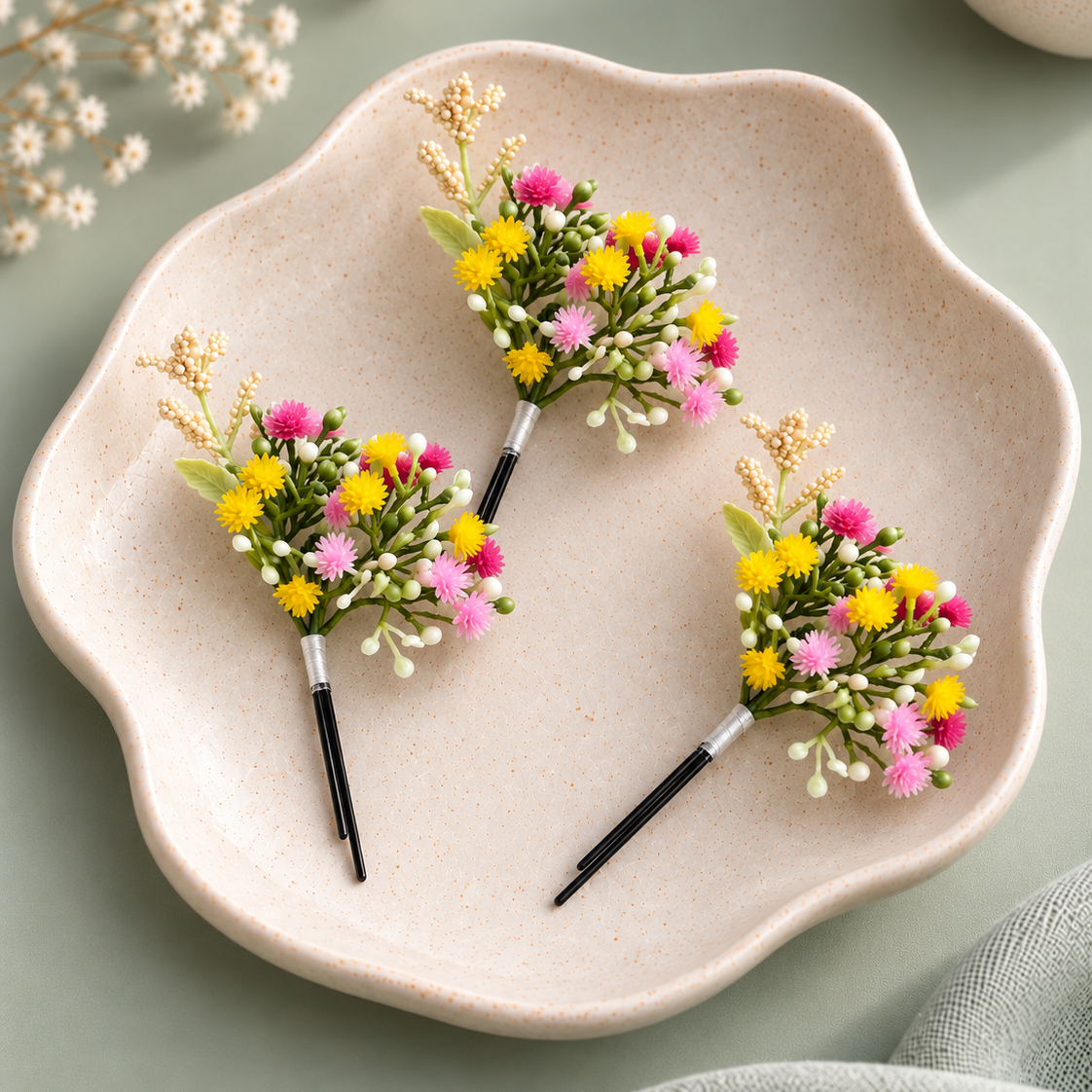 A delicate artificial floral hair accessory made with clustered pink and yellow flowers, white buds and green stems, suitable for festive and bridal hairstyles.