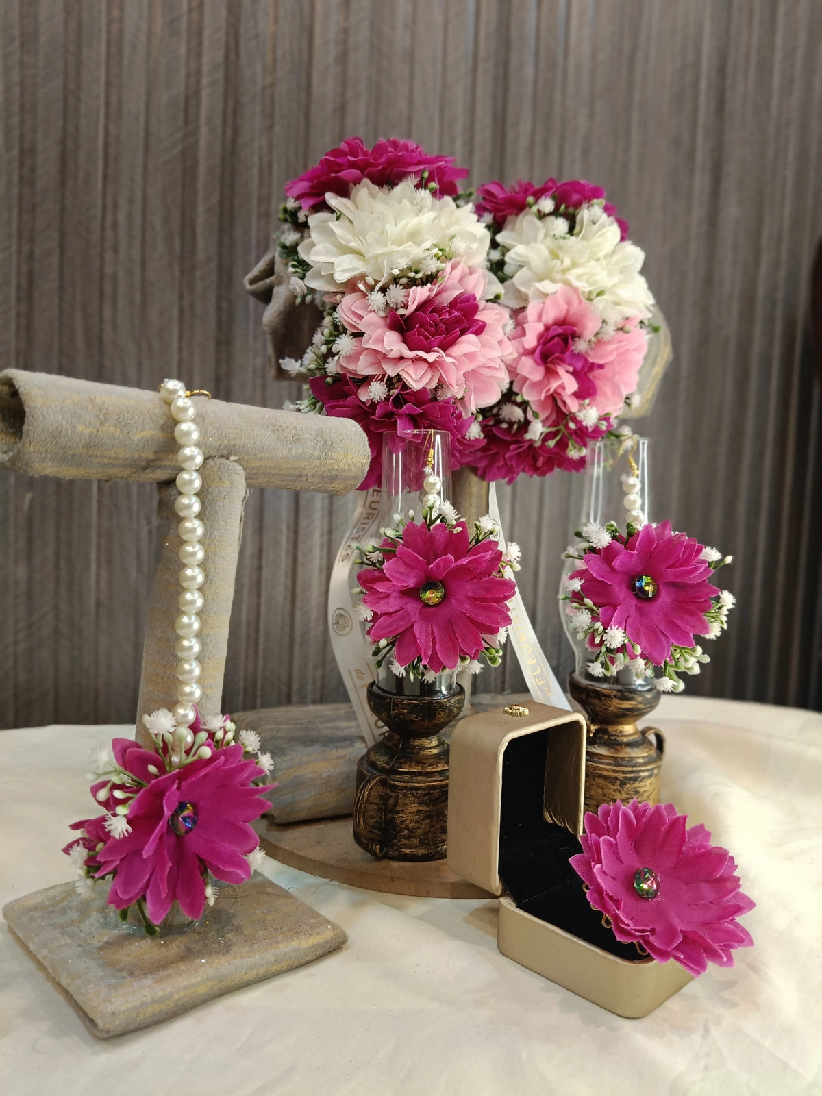 Gajra, earrings, tikka and rings across mixed flower tones