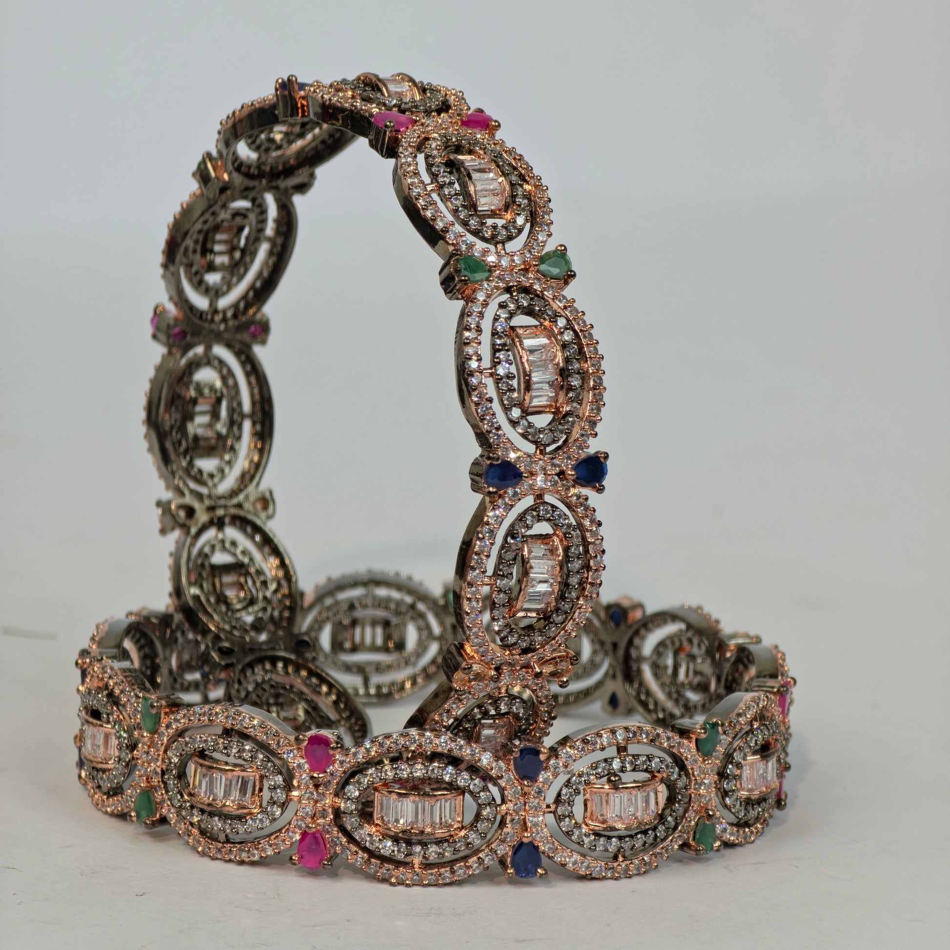 Decorative bracelet with gemstones on a light gray background