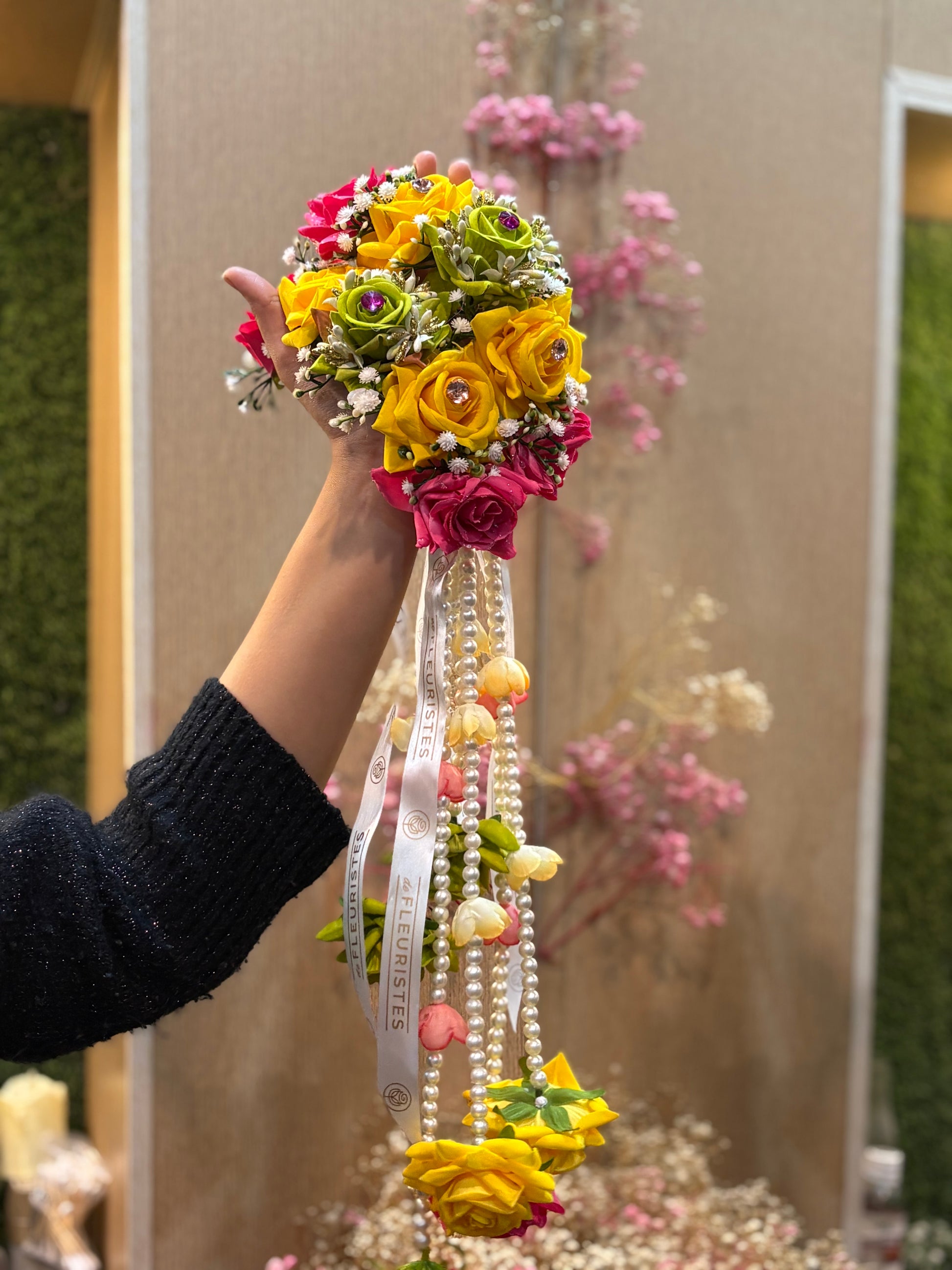 Close-up of premium artificial multi color buds on a hand gajra.