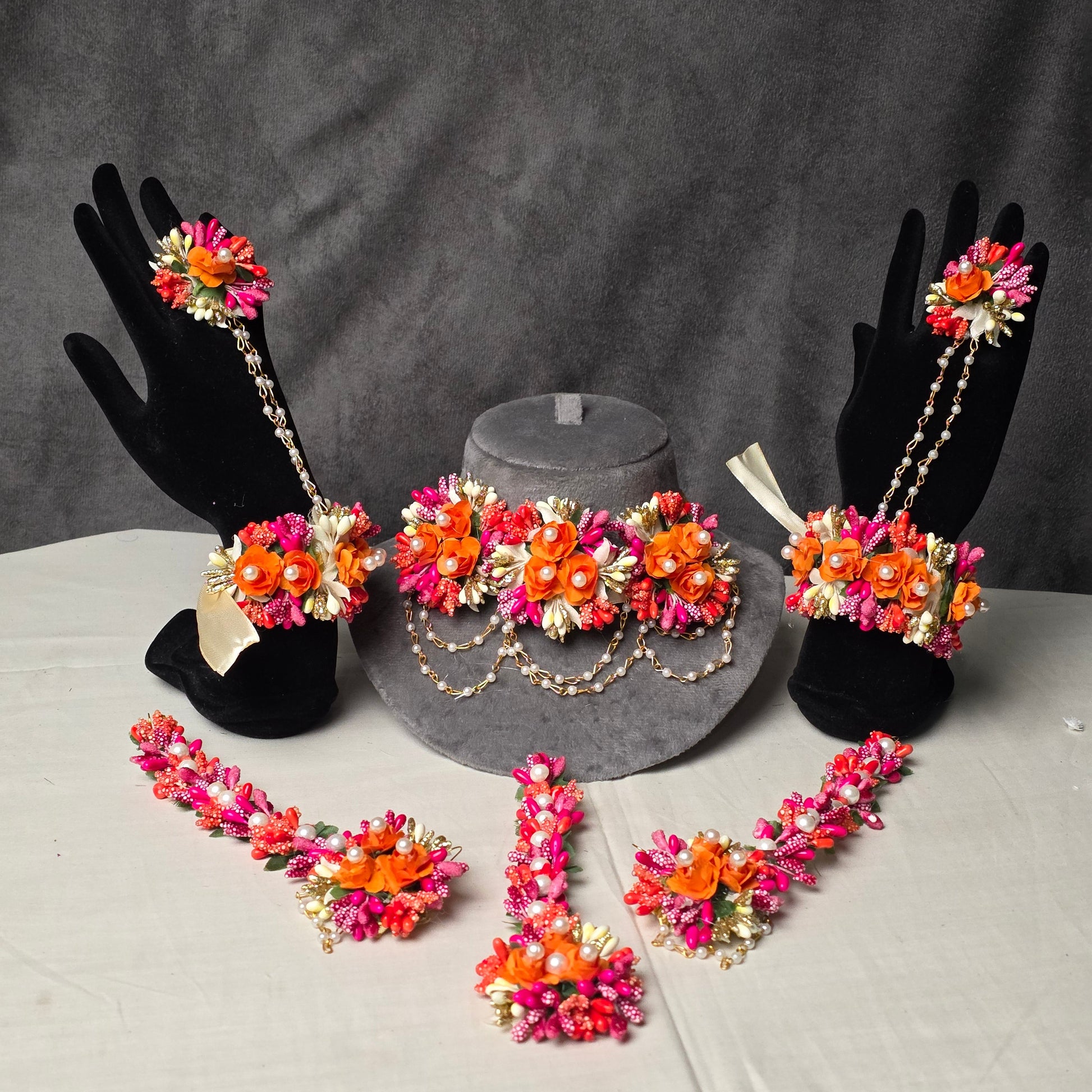 A beautiful artificial gajra pair featuring elegant attached rings for your hands.

Statement floral earrings complete with traditional saharay (hair chains).