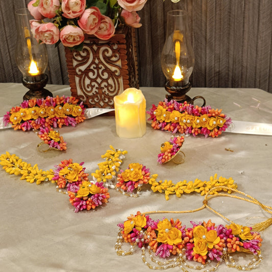 Premium artificial floral jewelry set designed for Mehndi and Henna Night celebrations, featuring handcrafted matching bridal accessories for Pakistani weddings.