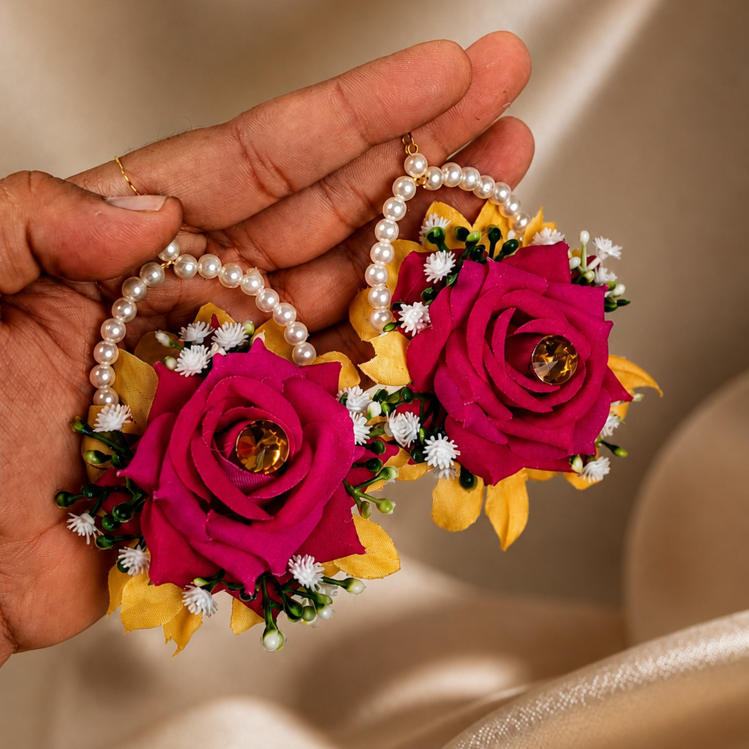 Statement Mehndi floral kaleeras featuring yellow and deep pink flowers, greenery, white fillers and multiple hanging pearl strands.