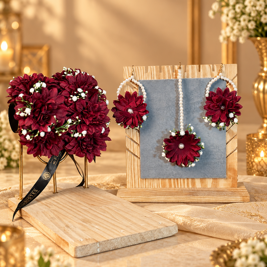Complete maroon bridal floral jewellery set featuring rich artificial flower gajras, pearl-loop earrings, matching tikka and delicate white floral accents for Pakistani wedding and Nikkah celebrations.