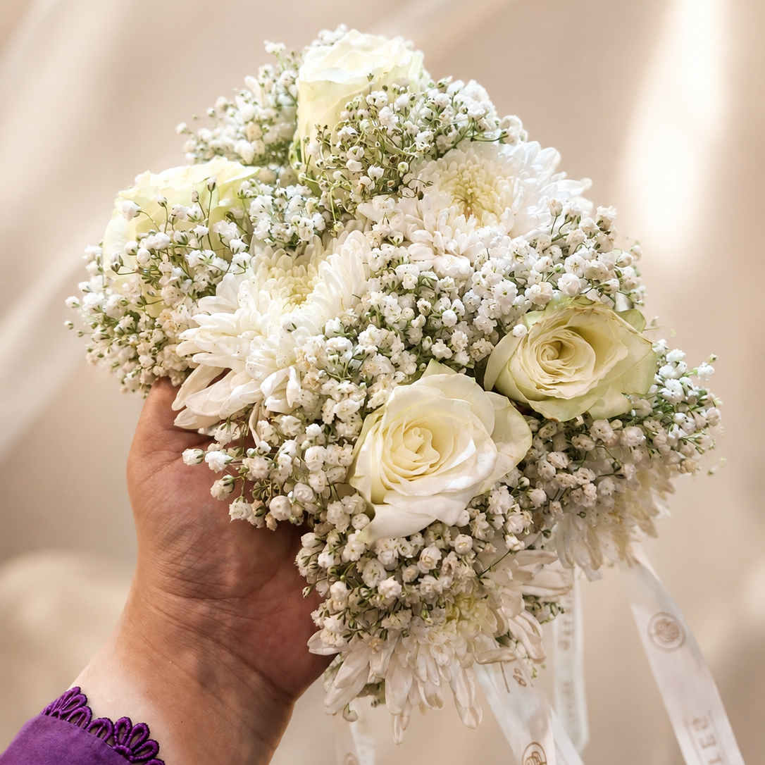 All-white fresh floral gajra pair designed with premium roses, chrysanthemums and baby’s breath for brides and wedding occasions.