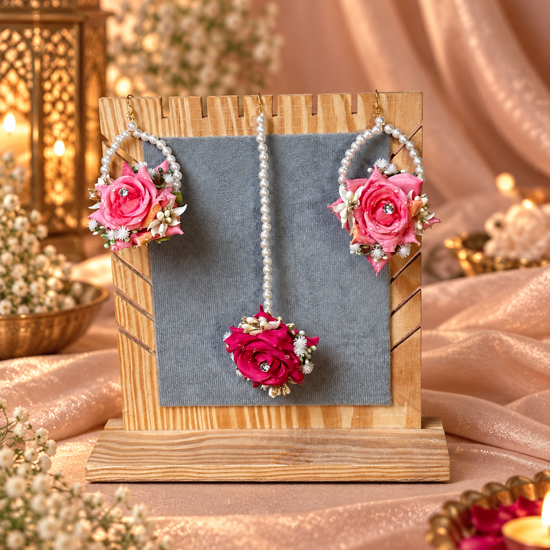 Matching pink flower earrings and tikka finished with pearl loops, layered rose clusters, white floral detailing and sparkling centres for a coordinated Pakistani bridal floral jewellery look.