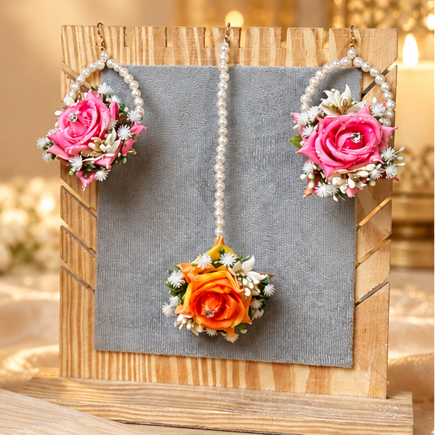 Matching flower earrings and tikka designed with pearl loops, pink and orange rose clusters, white floral accents and delicate crystal details to complete a colourful Pakistani bridal look.