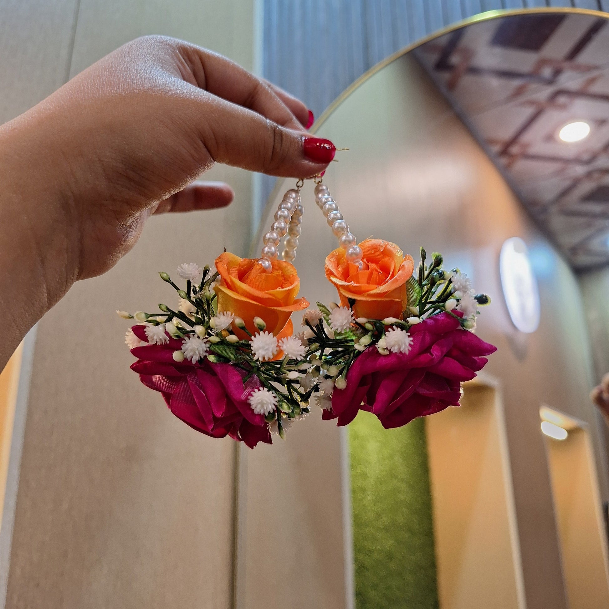 Statement floral earrings with velvet and silk roses, baby’s breath flowers, and a white pearl hoop, handcrafted by De Fleuristes.