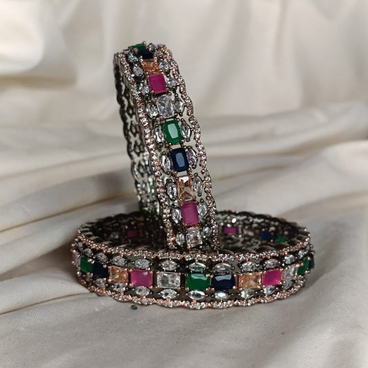 Decorative ring holder with multicolored gemstones on a white fabric background