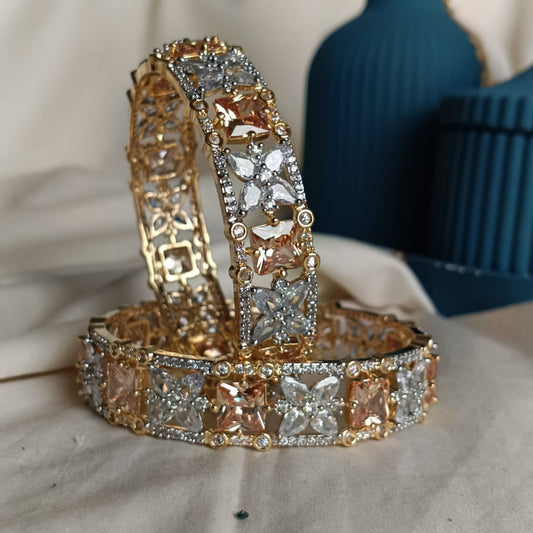 Gold and diamond bracelet on a textured surface with a blurred background