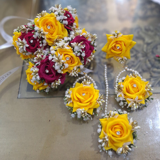 Delicate bloom complete artificial floral jewellery set including gajra pair, earrings, bindi, and ring for a mehndi bride.