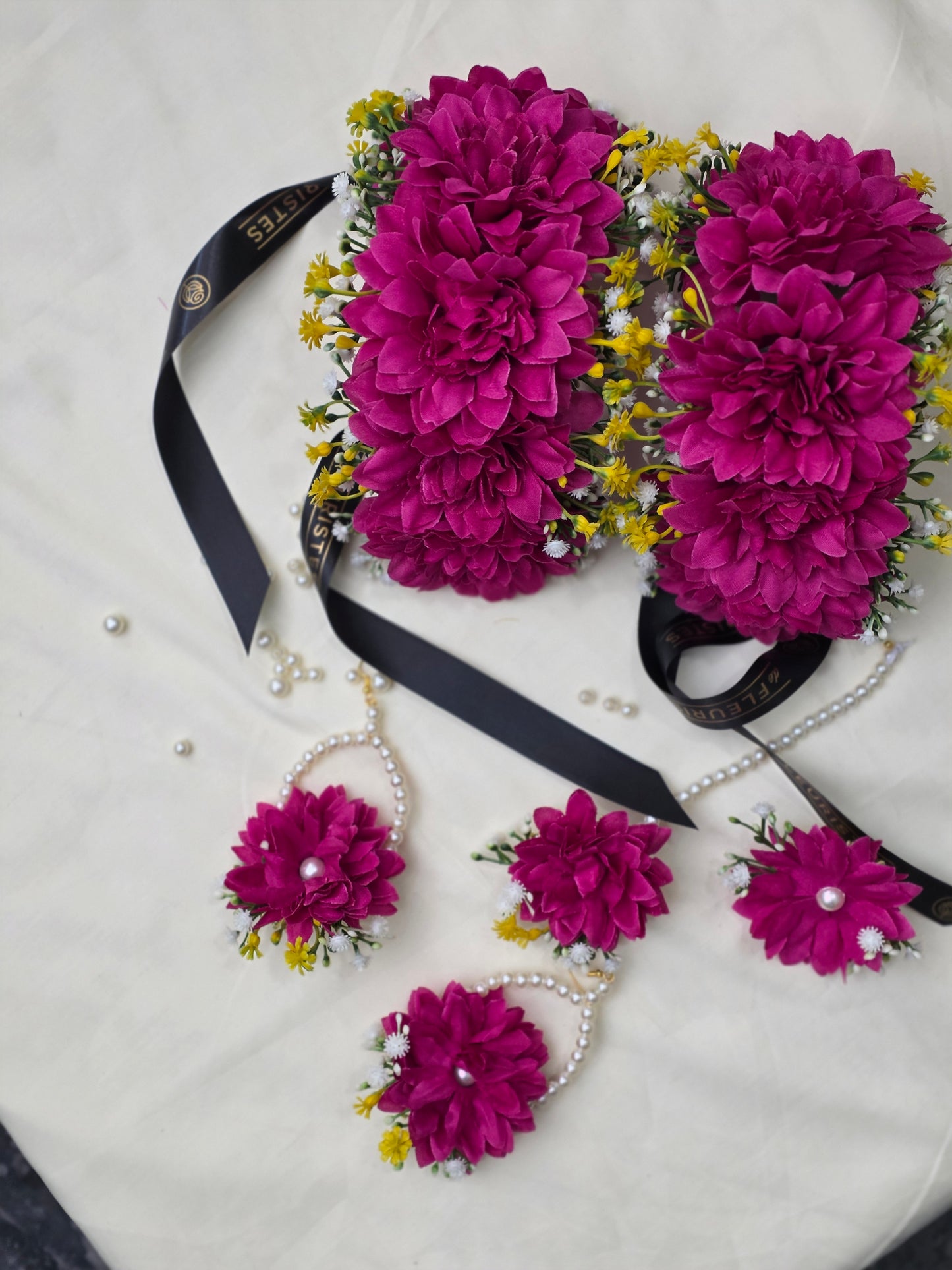 Close-up shot of the vivid hot pink artificial flowers and delicate preserved dried textures on the Hot Pink Bliss jewelry set.