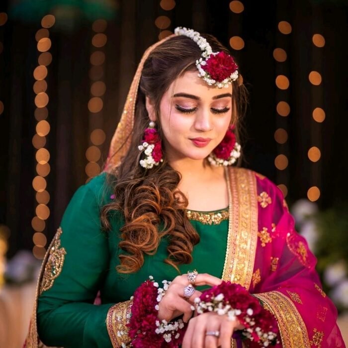 Maroon and white floral jewelry is meticulously crafted using chrysanthemums and baby’s breath.