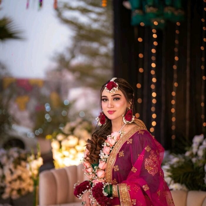 Maroon and white floral jewelry is meticulously crafted using chrysanthemums and baby’s breath.